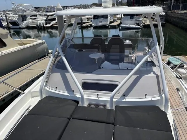Slide: The Image of 2023 Jeanneau Leader 9.0 WA boat docked at marina, featuring sleek design and spacious seating. - 31