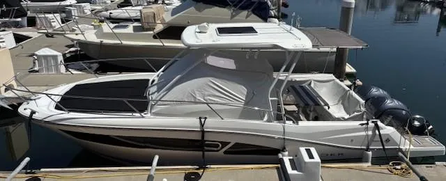 Slide: The Image of 2023 Jeanneau Leader 9.0 WA boat docked at marina, side view. - 4