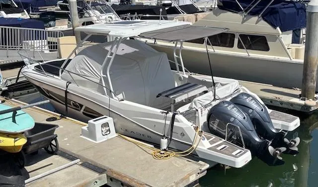 Slide: The Image of 2023 Jeanneau Leader 9.0 WA boat docked with twin outboard engines. - 5