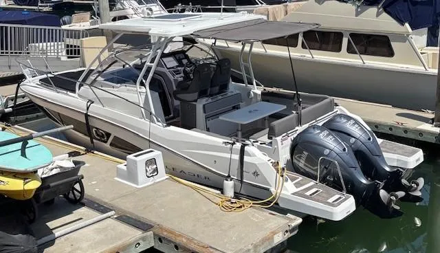 Slide: The Image of 2023 Jeanneau Leader 9.0 WA boat docked with twin engines and spacious deck. - 6