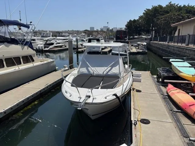 Slide: The Image of 2023 Jeanneau Leader 9.0 WA docked at a marina with surrounding boats. - 8