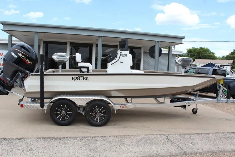 The Image of 2026 Excel Bay Pro Elite 203 boat on trailer, parked outside dealership. - 0