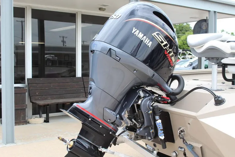 Slide: The Image of 2026 Excel Bay Pro Elite 203 with Yamaha outboard motor, parked outdoors. - 12
