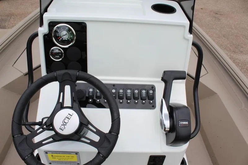 Slide: The Image of 2026 Excel Bay Pro Elite 203 boat dashboard with steering wheel and controls. - 13