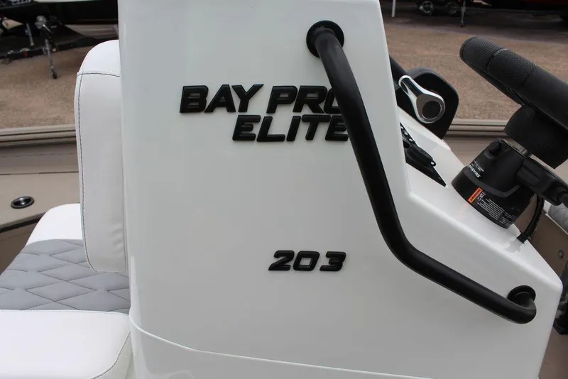 Slide: The Image of 2026 Excel Bay Pro Elite 203 boat console with steering wheel and seating. - 14