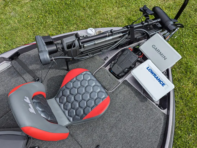 Slide: The Image of 2026 Bass Cat Lynx STS boat interior with Garmin and Lowrance electronics, red and gray seat. - 11