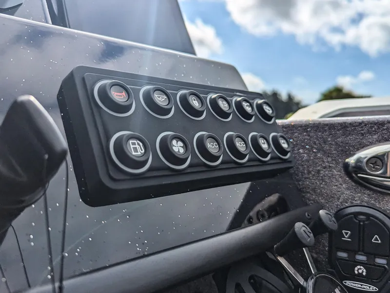 Slide: The Image of Control panel of 2026 Bass Cat Lynx STS boat with multiple buttons and switches. - 15