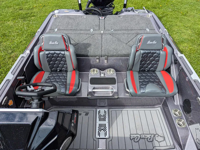 Slide: The Image of 2026 Bass Cat Lynx STS boat interior with dual seats and steering wheel. - 9