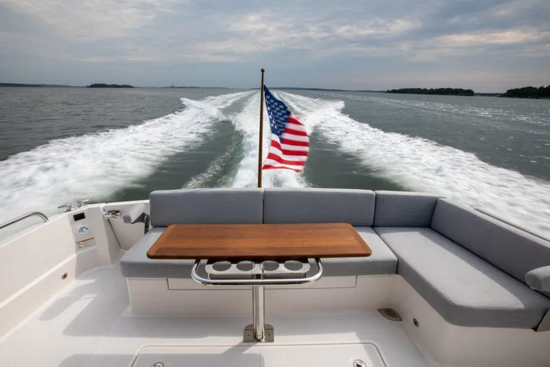 Slide: The Image of 2026 Sabre 43 Salon Express cruising with American flag, spacious seating, and ocean view. - 11