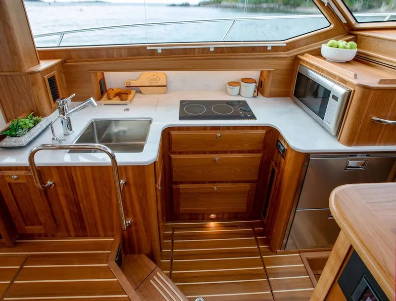 Slide: The Image of Luxurious kitchen interior of 2026 Sabre 43 Salon Express yacht with wooden cabinetry. - 23