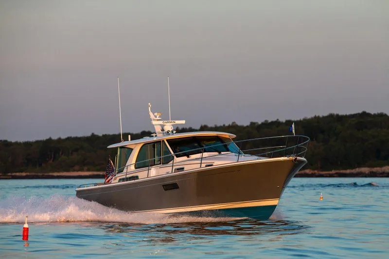 Slide: The Image of 2026 Sabre 43 Salon Express cruising on calm waters at sunset. - 3