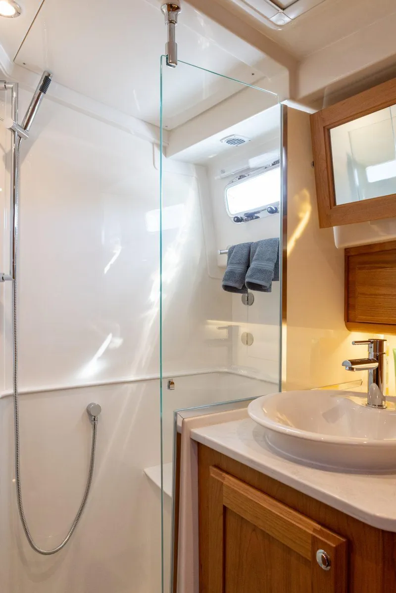 Slide: The Image of Modern bathroom in 2026 Sabre 43 Salon Express yacht with glass shower and wooden cabinetry. - 31