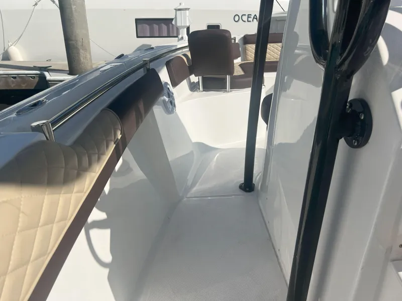 Slide: The Image of 2026 Reflex Gladiator 2400 boat interior with cushioned seating and sleek design. - 19