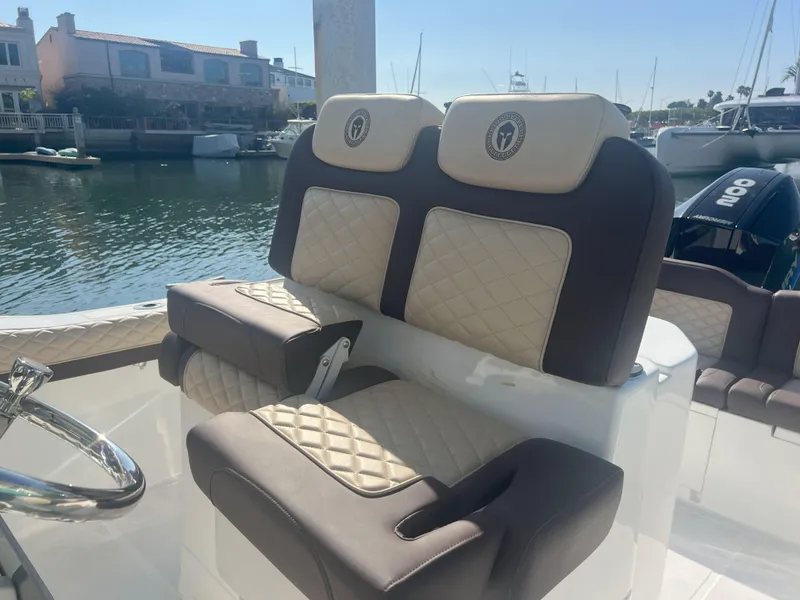 Slide: The Image of Luxurious seating on a 2026 Reflex Gladiator 2400 boat, docked in a marina. - 23