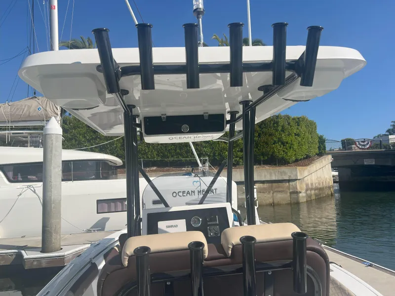 Slide: The Image of Reflex Gladiator 2400 boat, 2026 model, docked with rod holders and console, sunny day. - 26