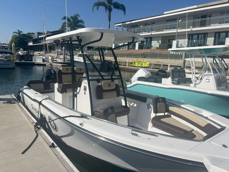 Slide: The Image of 2026 Reflex Gladiator 2400 boat docked at marina, featuring sleek design and modern amenities. - 4