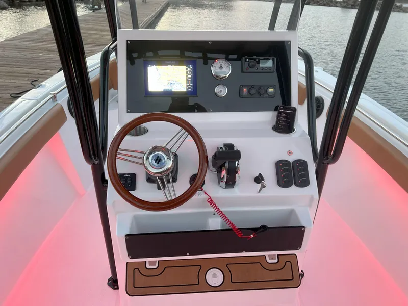 Slide: The Image of Boat dashboard of Reflex Gladiator 2400, 2026 model, with steering wheel and navigation controls. - 43