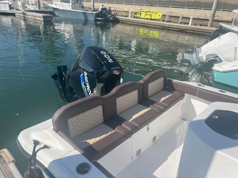 Slide: The Image of Luxury boat interior with cushioned seating, featuring a powerful Mercury outboard motor. Reflex Gladiator 2400, 2026 model. - 7