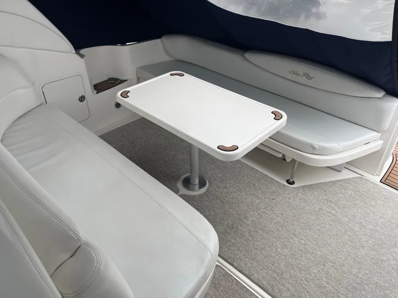 Slide: The Image of Interior of 2000 Sea Ray 340 Sundancer with white seating and table. - 15