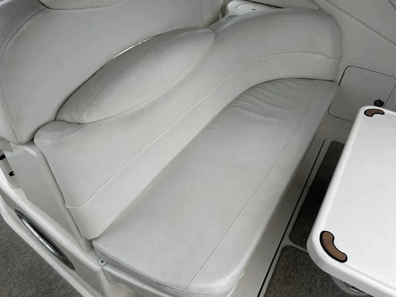 Slide: The Image of White leather seating on a 2000 Sea Ray 340 Sundancer boat, with adjacent table. - 17