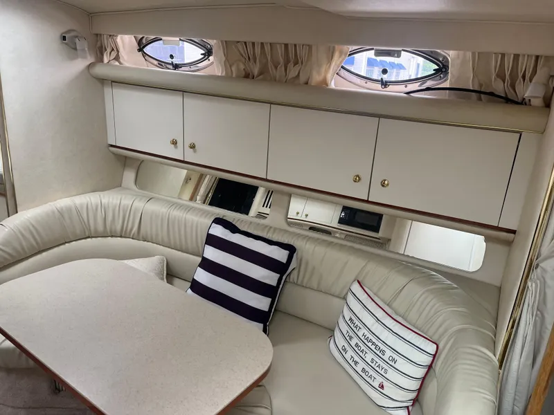 Slide: The Image of Interior of 2000 Sea Ray 340 Sundancer with cozy seating and nautical decor. - 20