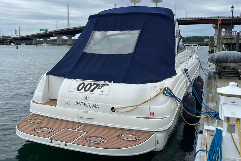 Slide: The Image of 2000 Sea Ray 340 Sundancer docked, featuring blue cover and wooden deck, in Beverly, MA. - 24