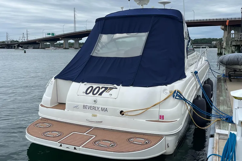 Slide: The Image of 2000 Sea Ray 340 Sundancer docked, featuring blue canopy and wooden deck, Beverly, MA. - 25