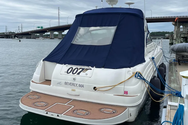 Slide: The Image of 2000 Sea Ray 340 Sundancer docked, featuring blue canopy and wooden deck, Beverly, MA. - 26