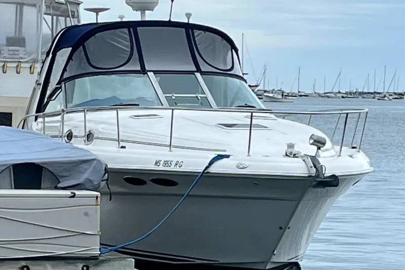 Slide: The Image of 2000 Sea Ray 340 Sundancer yacht docked at marina, calm waters, overcast sky. - 28
