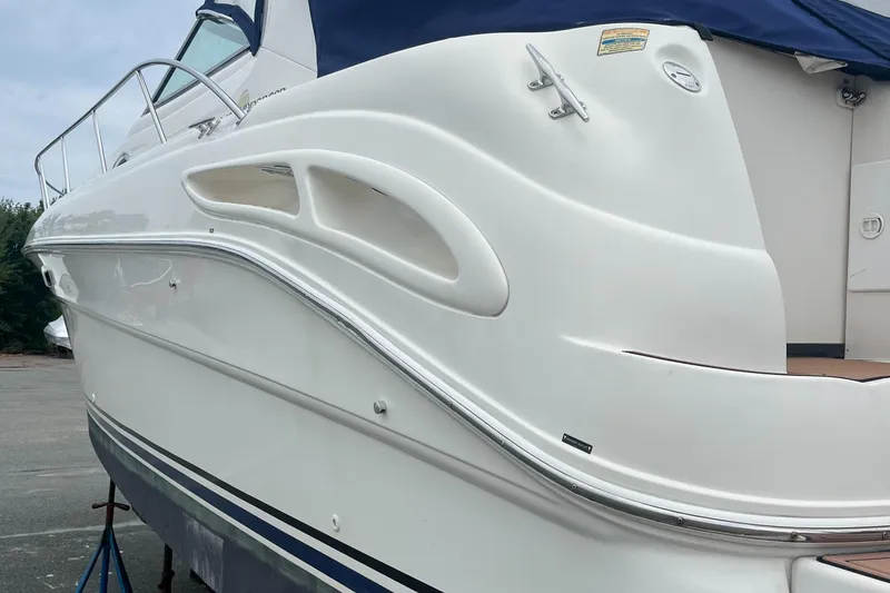 Slide: The Image of 2000 Sea Ray 340 Sundancer boat, white hull, docked, side view. - 30