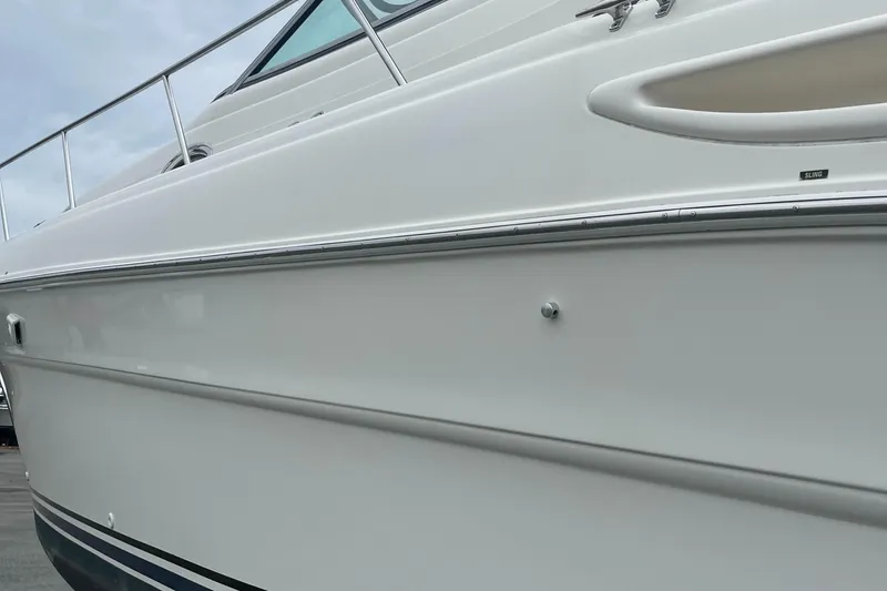 Slide: The Image of Side view of a 2000 Sea Ray 340 Sundancer boat, showcasing sleek white hull design. - 31