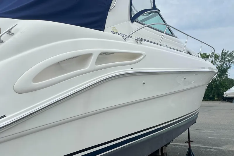 Slide: The Image of 2000 Sea Ray 340 Sundancer boat, white hull, docked outdoors. - 32