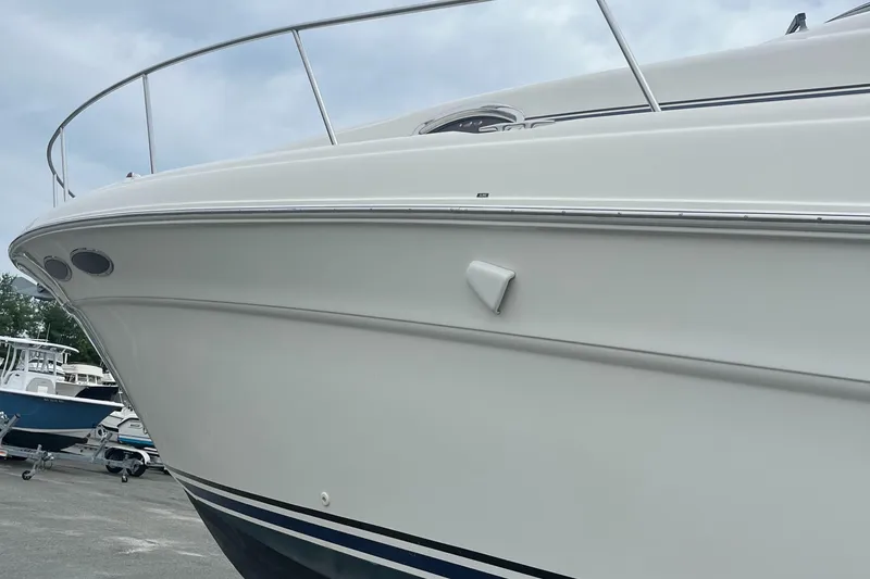 Slide: The Image of 2000 Sea Ray 340 Sundancer boat, white hull, docked in a marina. - 33