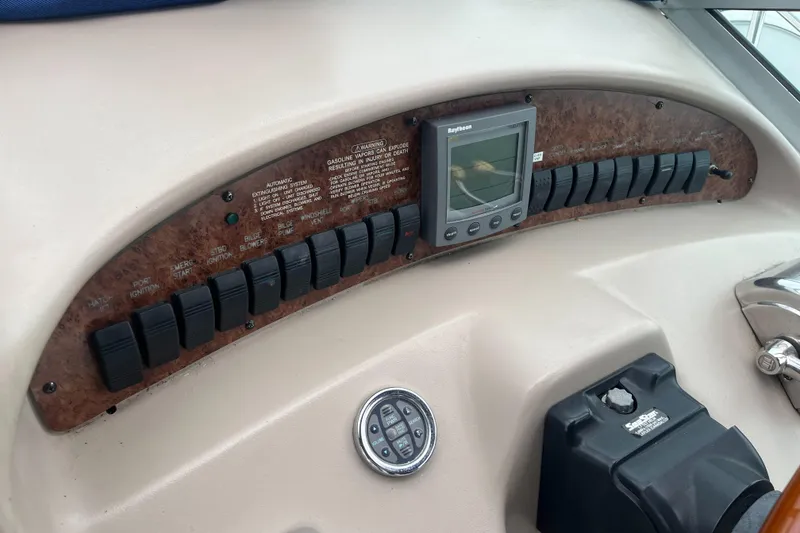 Slide: The Image of Control panel of a 2000 Sea Ray 340 Sundancer boat with switches and display. - 40