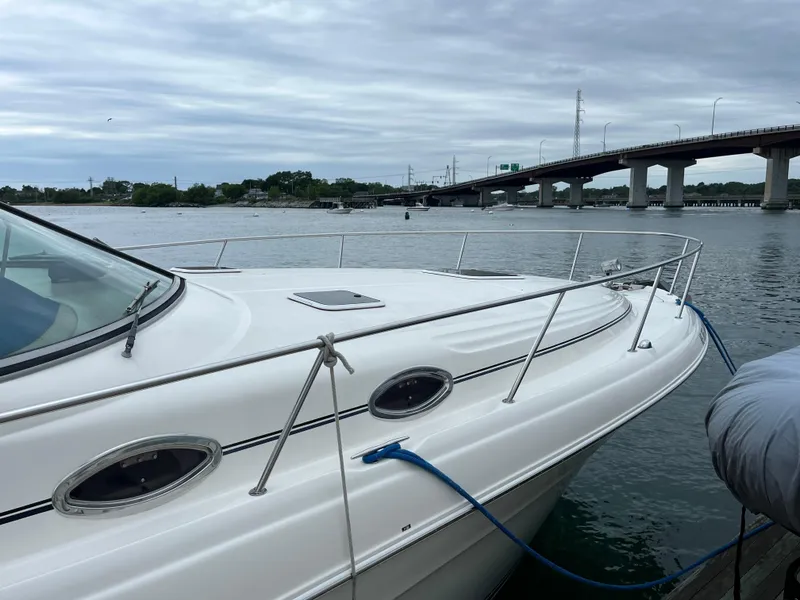 Slide: The Image of 2000 Sea Ray 340 Sundancer yacht docked near a bridge on a cloudy day. - 5