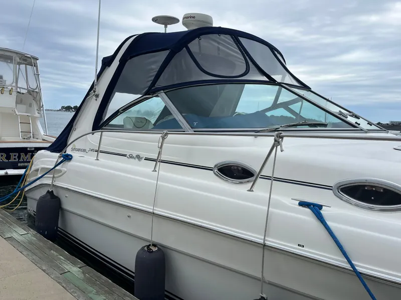 Slide: The Image of 2000 Sea Ray 340 Sundancer yacht docked at marina with blue canopy. - 6