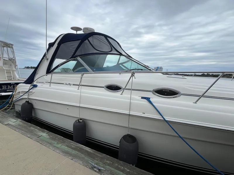 Slide: The Image of 2000 Sea Ray 340 Sundancer yacht docked with overcast sky. - 7