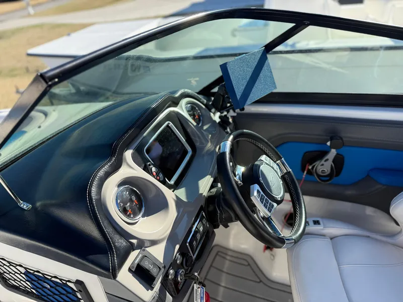 Slide: The Image of 2017 Chaparral Vortex 2430 VRX boat dashboard with steering wheel and control panel. - 5