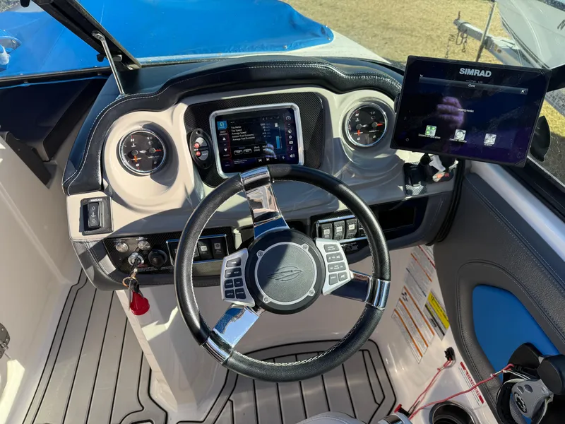 Slide: The Image of 2017 Chaparral Vortex 2430 VRX boat dashboard with steering wheel and digital displays. - 6