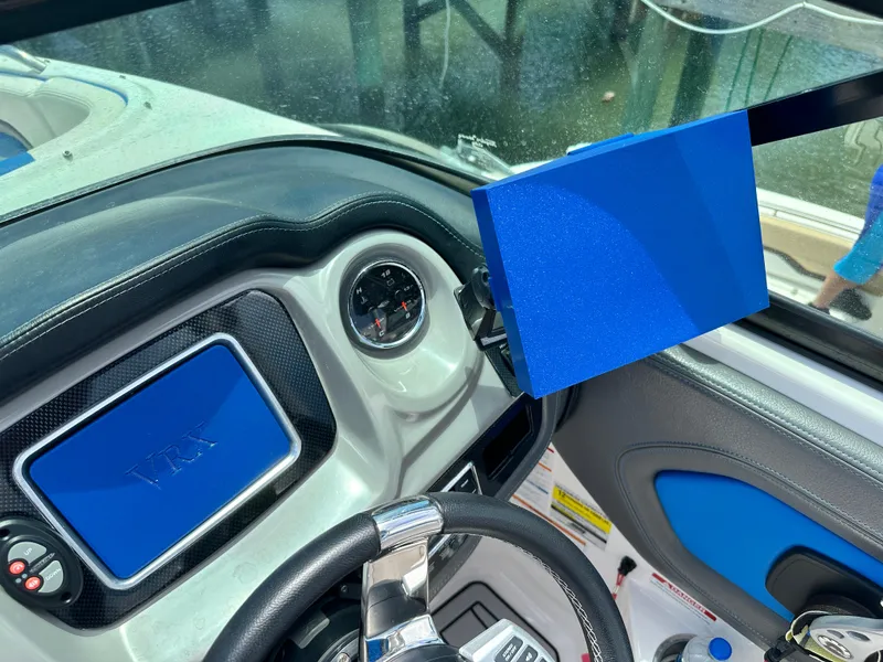 Slide: The Image of 2017 Chaparral Vortex 2430 VRX dashboard with steering wheel and blue display screen. - 9