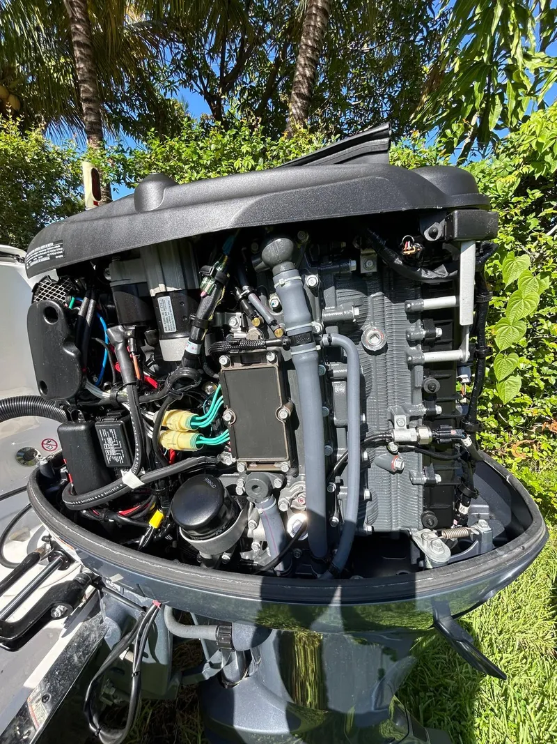 Slide: The Image of 2018 Robalo R222 outboard engine with detailed internal components, surrounded by lush greenery. - 13