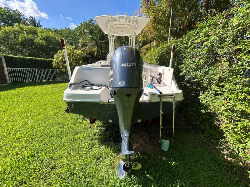 Slide: The Image of 2018 Robalo R222 boat with Yamaha 200 engine, parked on grass. - 2