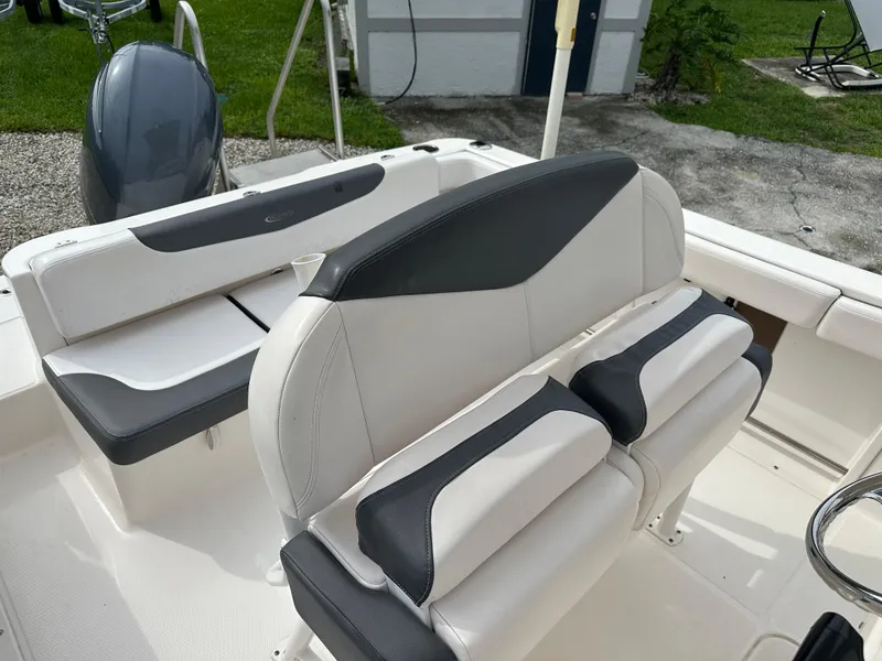 Slide: The Image of 2018 Robalo R222 boat interior with white and gray seating, showcasing modern design. - 4