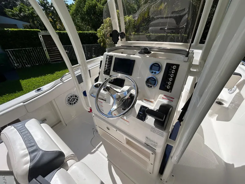 Slide: The Image of 2018 Robalo R222 boat cockpit with steering wheel and control panel. - 6