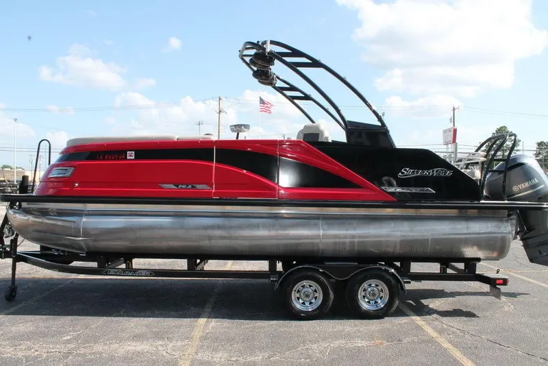 Slide: The Image of 2021 Silver Wave 2410 SW5 JS pontoon boat on trailer, red and black design. - 3