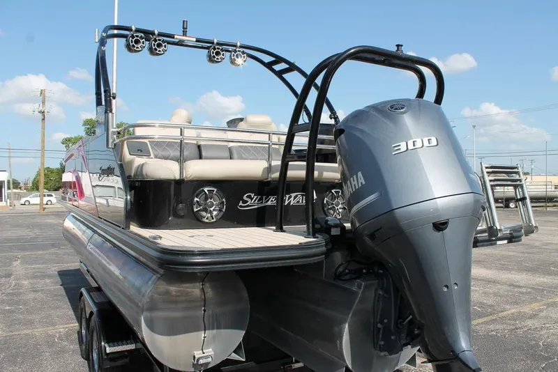 Slide: The Image of 2021 Silver Wave 2410 SW5 JS pontoon boat with Yamaha 300 engine, parked outdoors. - 4