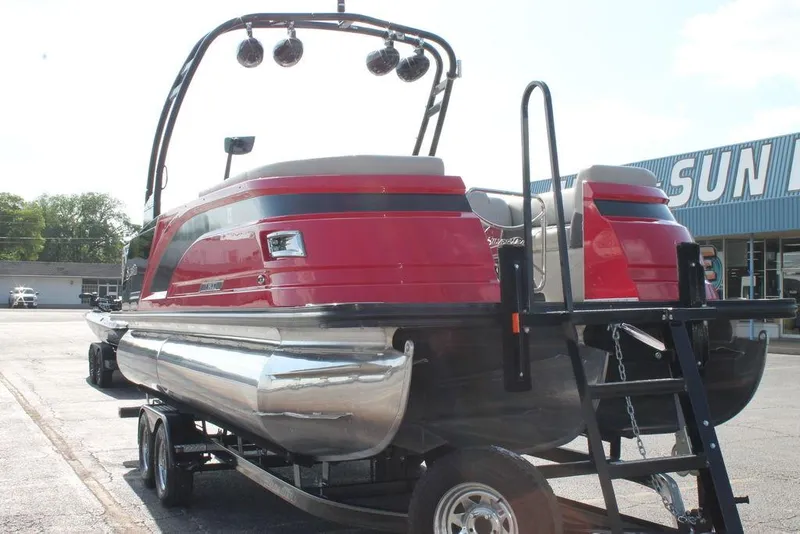 Slide: The Image of 2021 Silver Wave 2410 SW5 JS pontoon boat on trailer, red and silver design. - 6