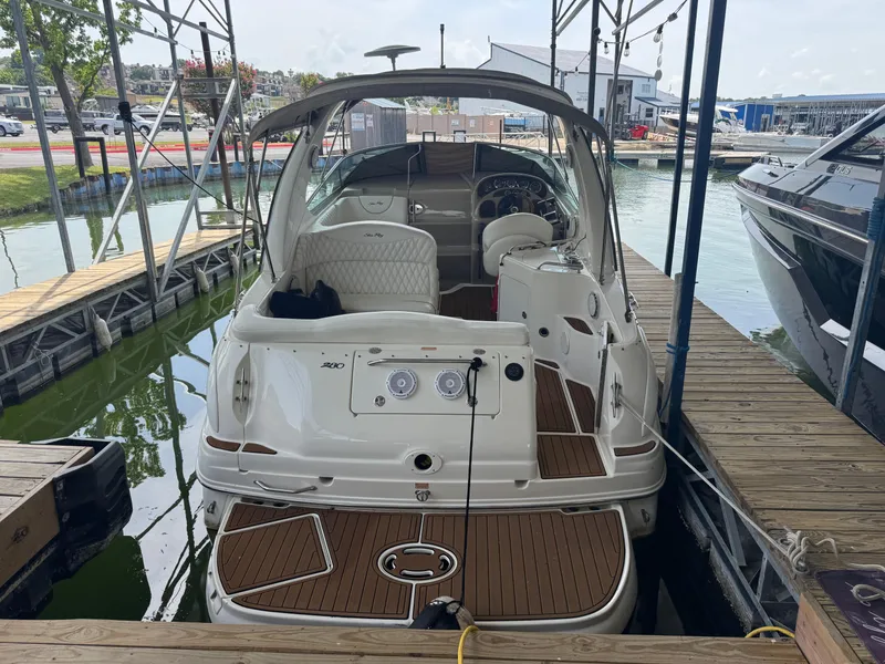 Slide: The Image of 2003 Sea Ray 280 Sundancer docked at marina, rear view showing deck and interior. - 3
