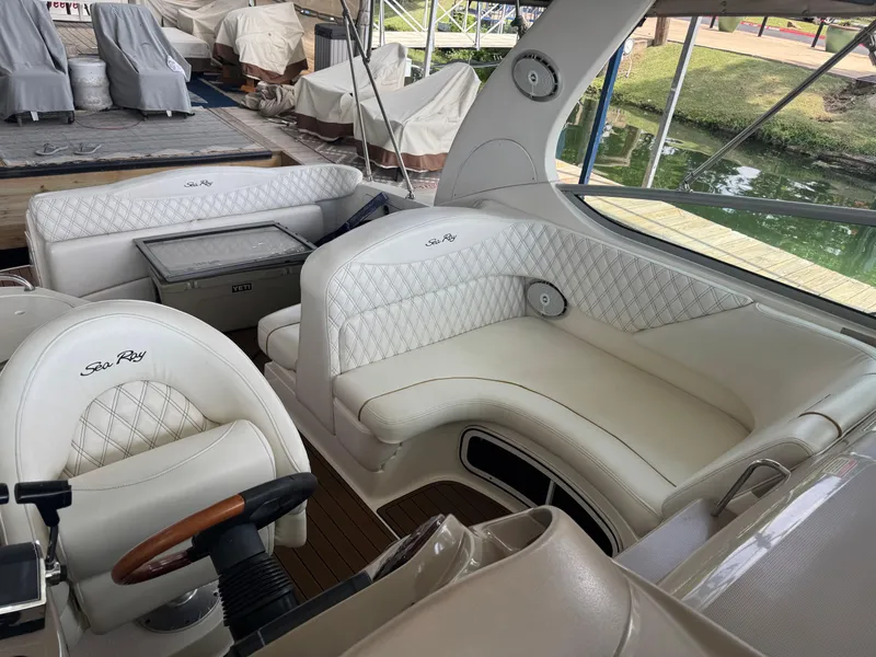 Slide: The Image of 2003 Sea Ray 280 Sundancer interior with white leather seating and wood accents. - 5