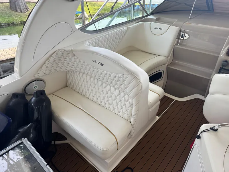 Slide: The Image of Luxurious interior of 2003 Sea Ray 280 Sundancer with white seating and wood flooring. - 6